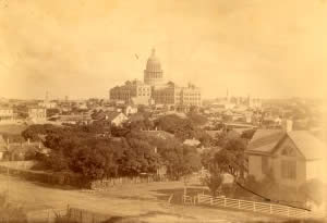 Photograph looking at Capitol from the northwest showing many residences and businesses in foreground