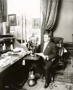 Photograph of Governor Colquitt seated at curtain desk