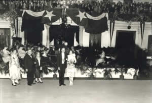Photograph of Governor and Mrs. Moody standing in front of bandstand at Inaugural Ball
