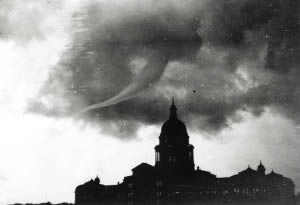 Photograph showing the Capitol dome against a dark sky with a large funnel cloud swirling nearby