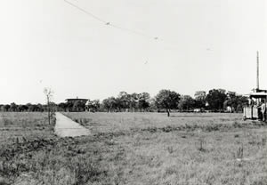 Photograph of Shipe residence in distance and streetcar entering scene on right