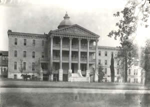 Photograph of three-story hospital building on the grounds of the Asylum