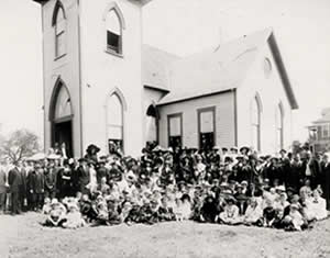 Photograph of large group of people in front of church building