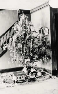 Photograph of decorated Christmas tree with model train circling underneath