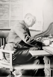 Photograph of Mr. Ramsey working at desk
