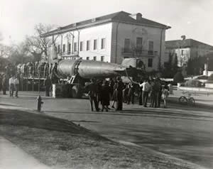 Photograph of submarine on platform parked in street beside Littlefield Fountain at the University of Texas campus