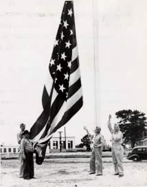 Photograph of soldiers raising American flag at Camp Swift