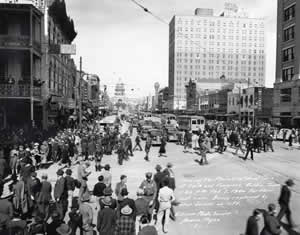 Photograph of Congress Avenue in 1940 showing streetcars and buses